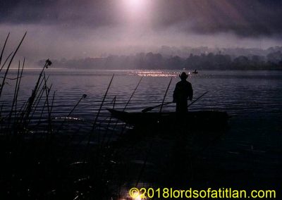 Fisherman in cayuco Santiago Atitlán in background.