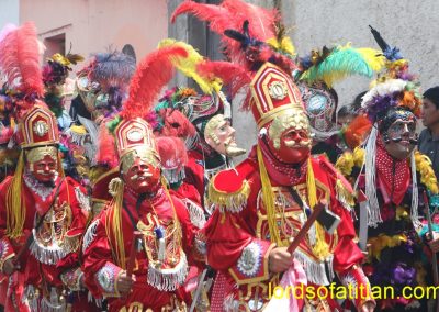 The Maya side of the Dance of the Conquest with the enemy in background. However, the feathered figure to right is Lacondón, who led Pedro de Alvarado's troops from Mexico.