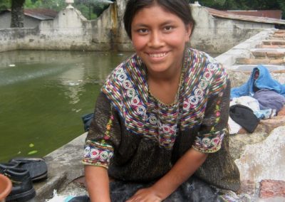 Woman from Joyabaj washing in public pila but in the finca Pampojilá, San Lucas Tolimán