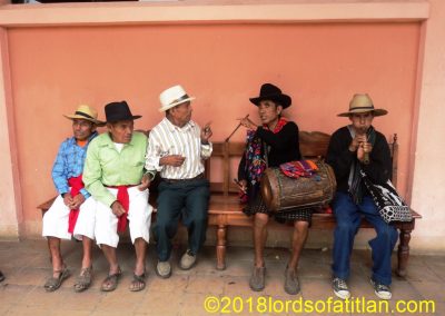I'm not sure what's going on here. However, it looks like a turf war for the bench between the men of Santa Clara and the musicians of Santa Catarina's hotlands in the Fair of Santa Clara la Laguna, Aug. 12th.