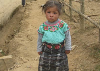 Little girl from Patzutzún bidding me farewell while Grandma looks on in the background.