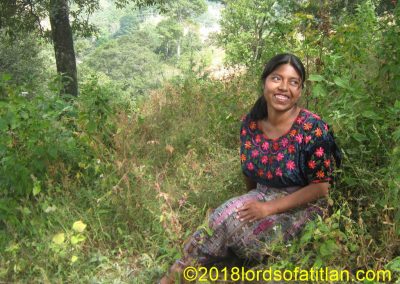 Woman from San Andrés Semetabaj seated in the weeds.