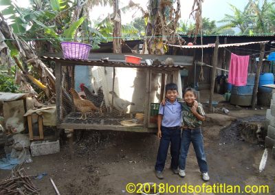 Boys with chickens in Panimaquip, San Lucas Tolimán