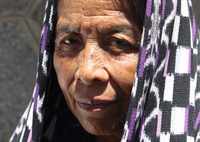 Woman walking in procession in San Pedro la Laguna
