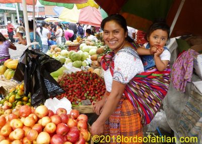 It appears the child is eating strawberries, but they are rambutan, a fruit similar to lichees.